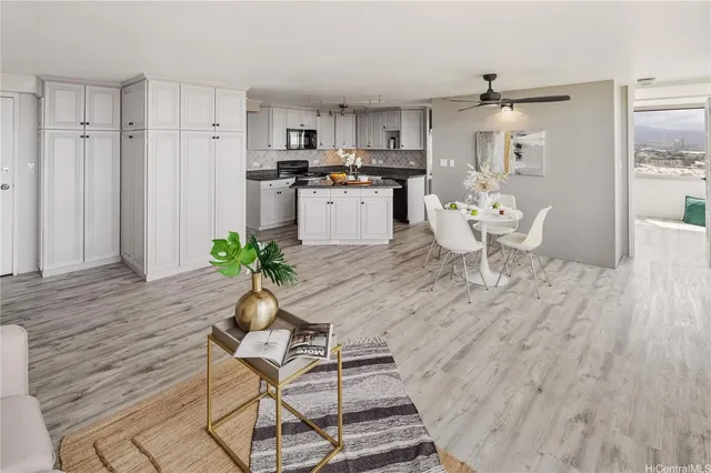 a kitchen with granite countertop white cabinets stainless steel appliances and dining table