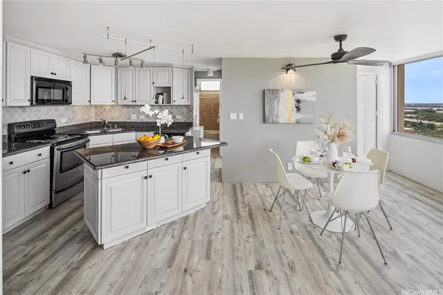 a kitchen with a table chairs refrigerator and cabinets