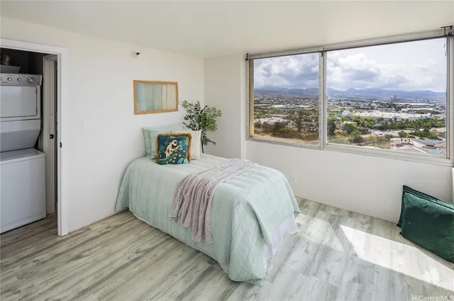 a bedroom with a large bed and a window