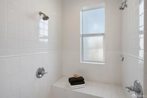 a bathroom with a shower and a window