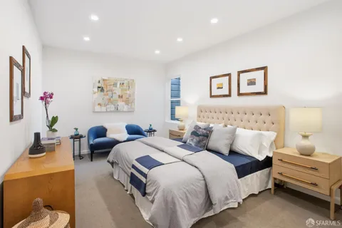 a bedroom with a bed and a couch