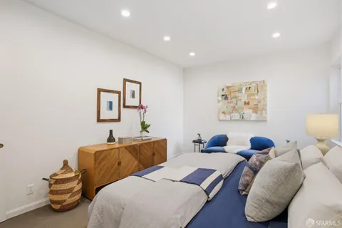 a bedroom with two beds and a lamp