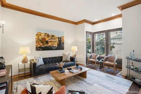 a living room with furniture a rug and a large window