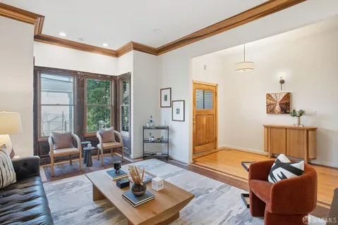 a living room with furniture rug and window