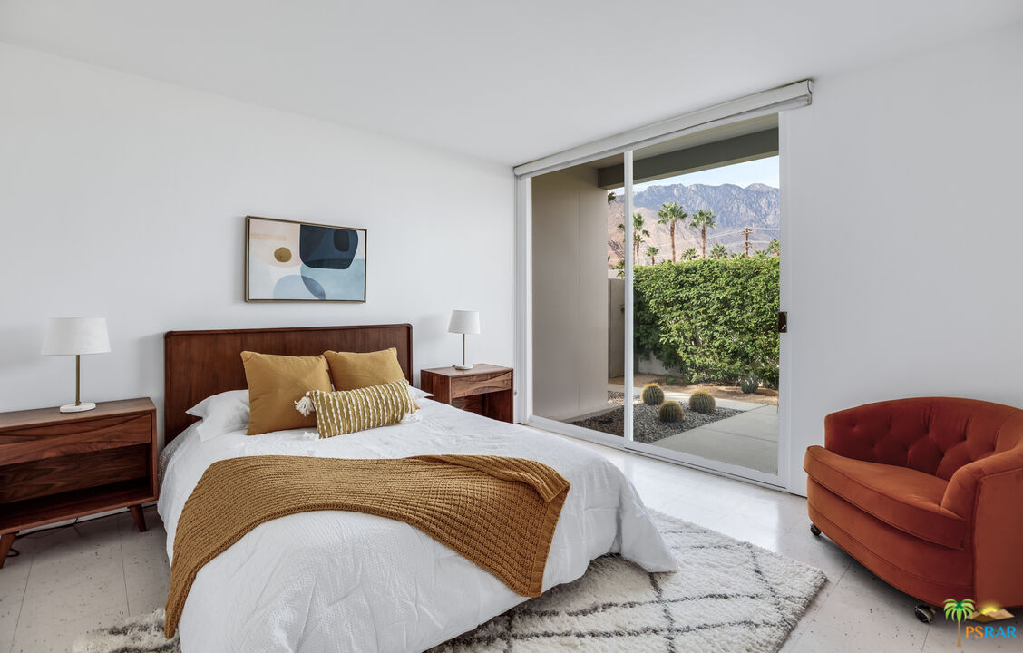 290 East Simms Road Palm Springs, CA 92262 - Photo 26 of 37 a bedroom with a bed and a couch next to a window