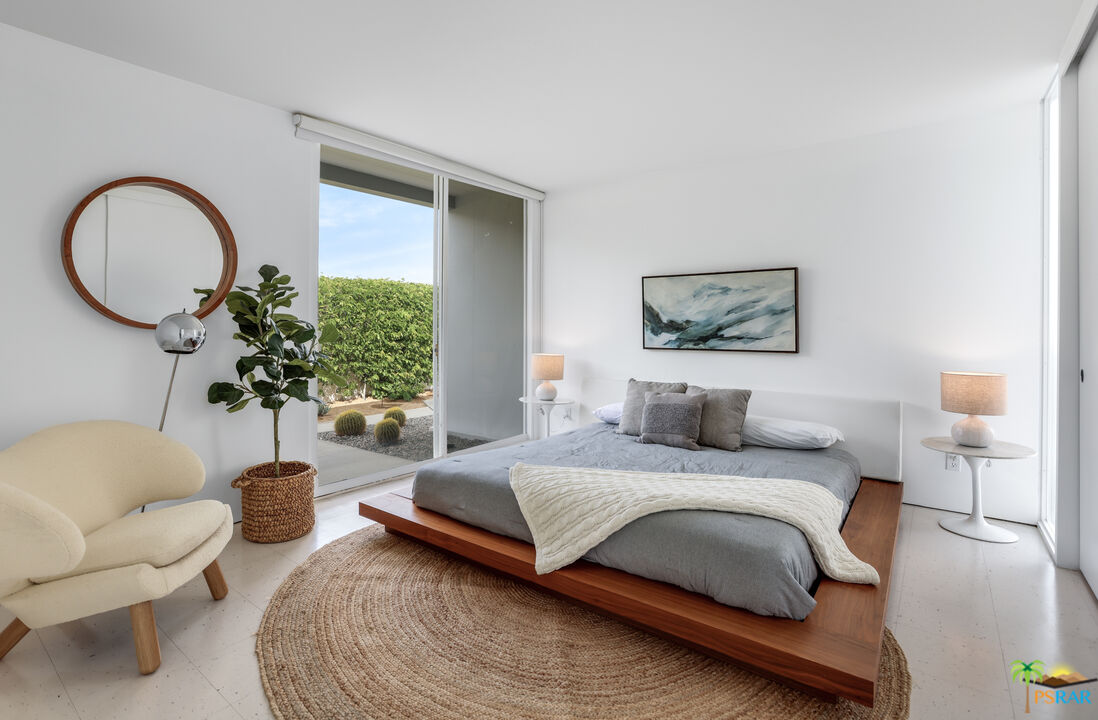 290 East Simms Road Palm Springs, CA 92262 - Photo 28 of 37 a bedroom with a bed a couch and a potted plant
