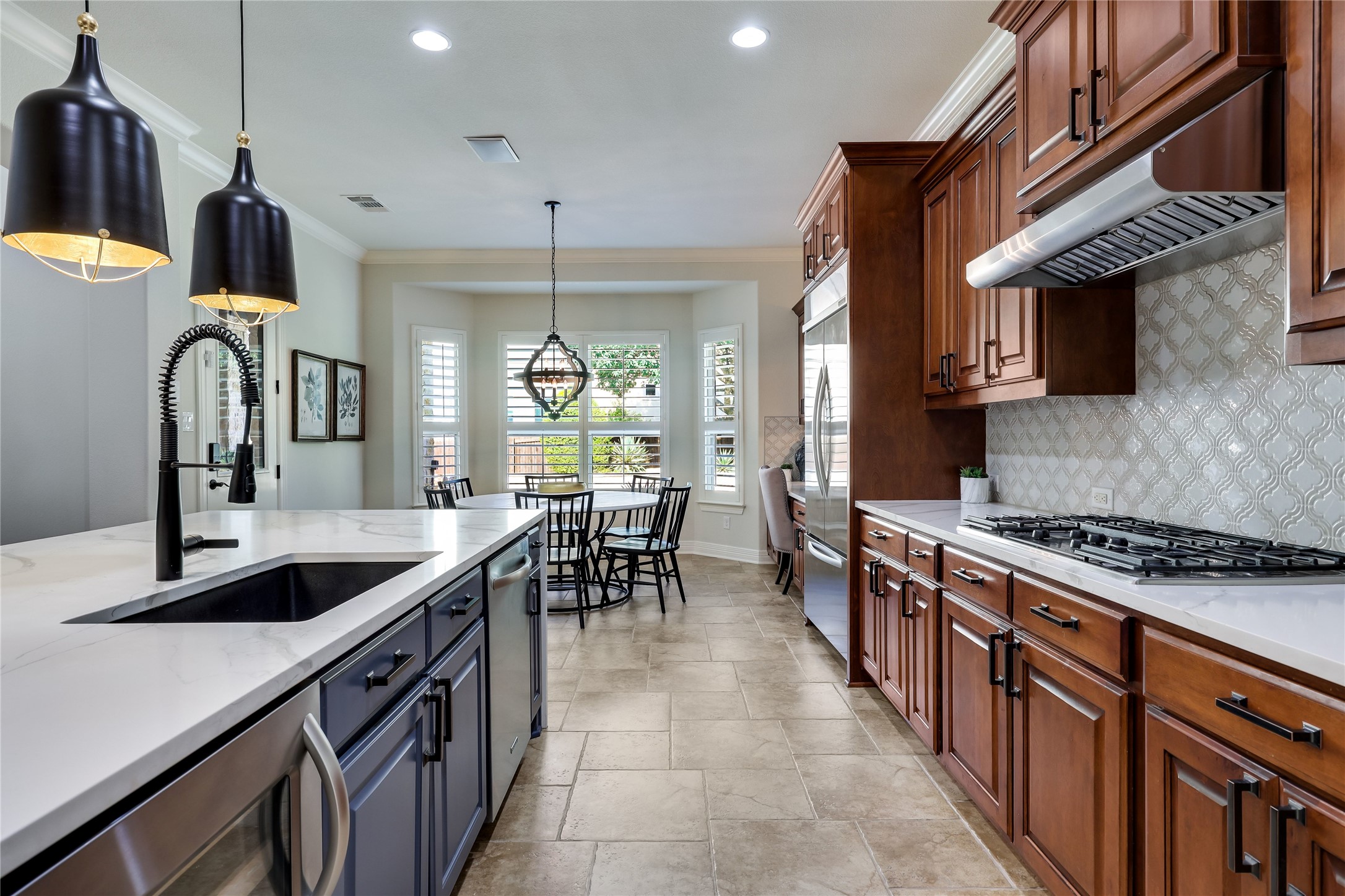 401 Bluff View Road Cedar Park, TX 78613 - Photo 21 of 40 Culinary excellence awaits in this kitchen featuring abundant wood cabinetry and pristine white countertops.
