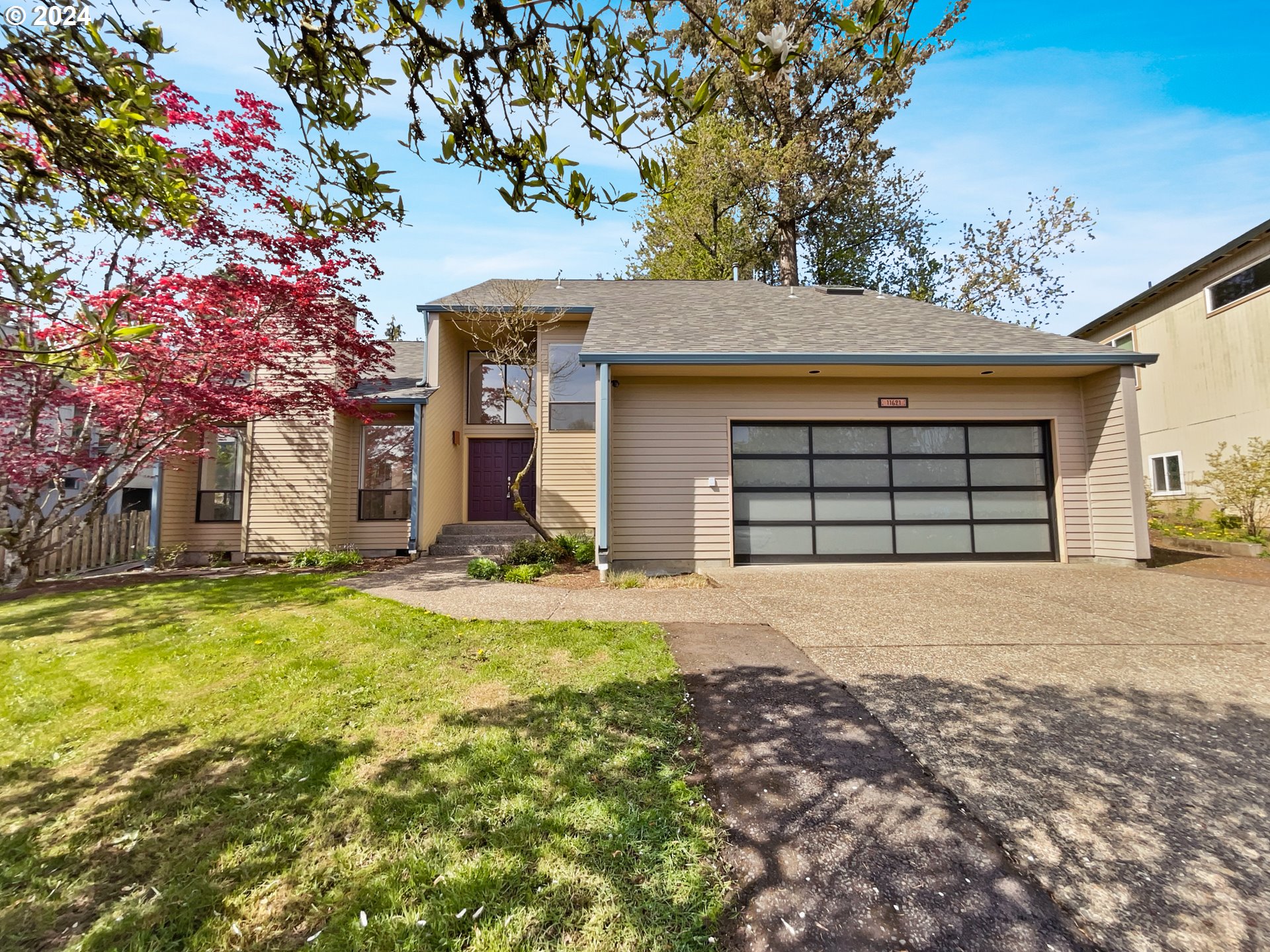a front view of a house with a yard and garage