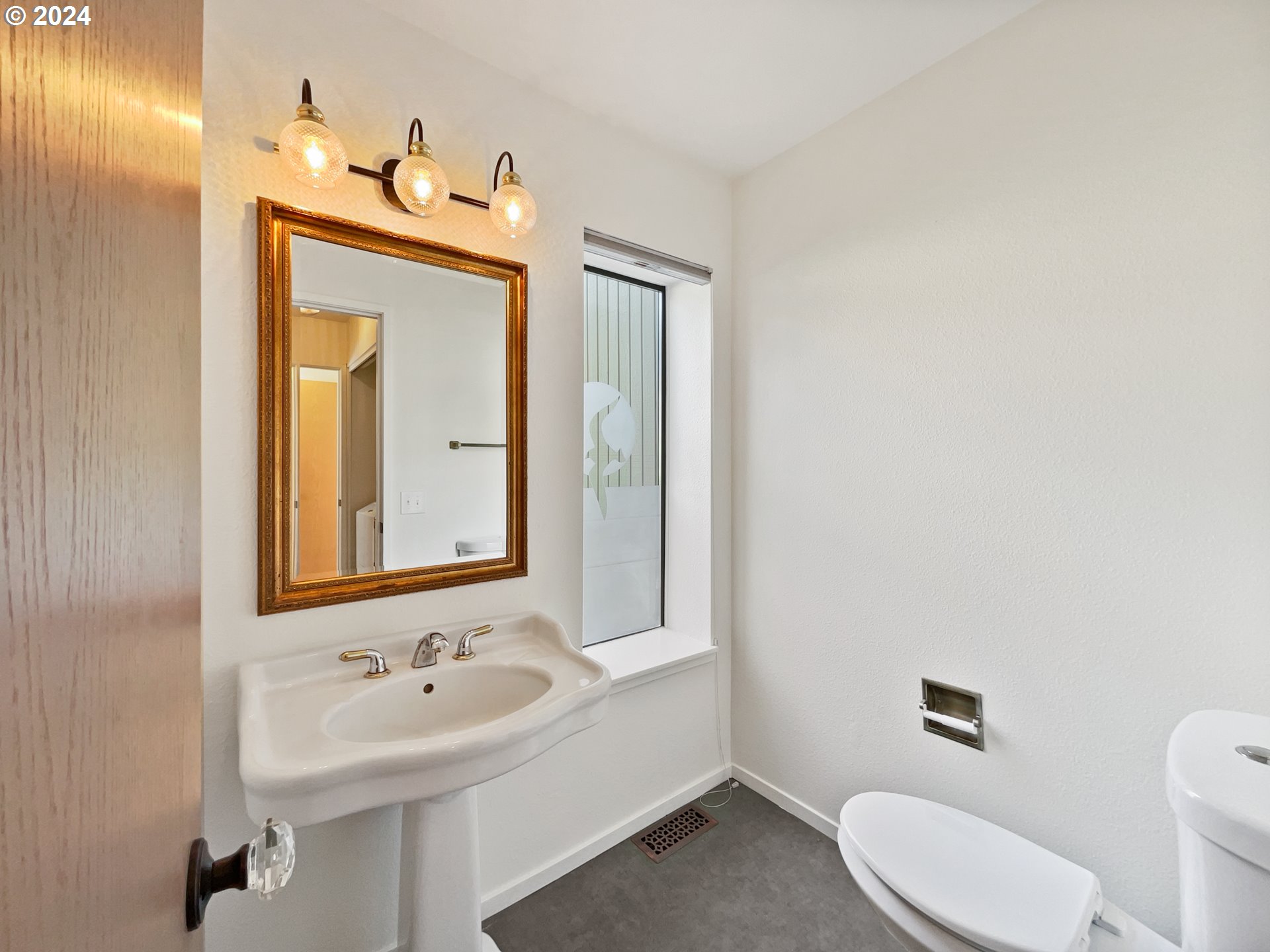 11621 Southwest 43rd Avenue Portland, OR 97219 - Photo 12 of 19 a bathroom with a toilet sink and mirror