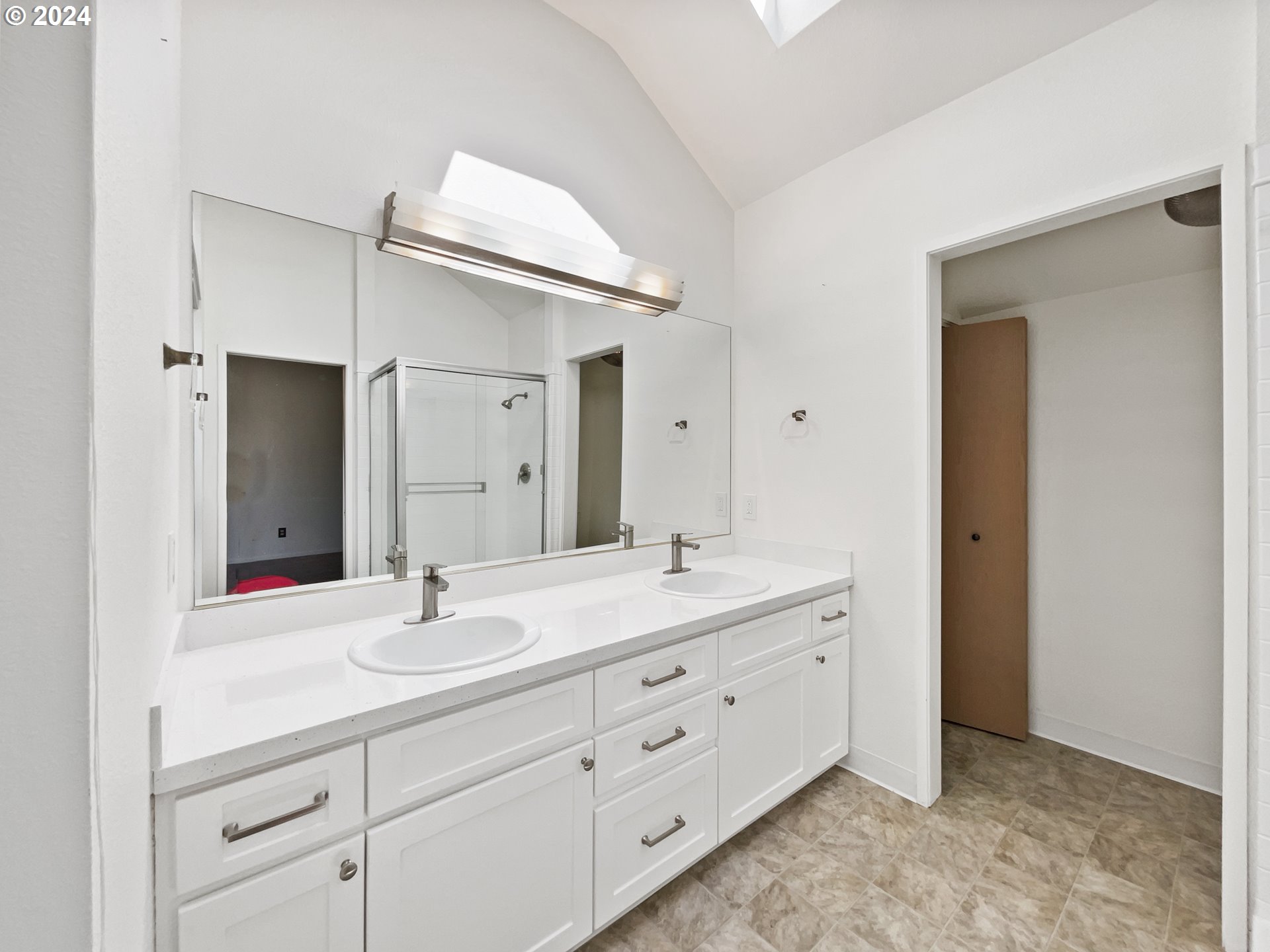 11621 Southwest 43rd Avenue Portland, OR 97219 - Photo 16 of 19 a bathroom with a double vanity sink mirror and