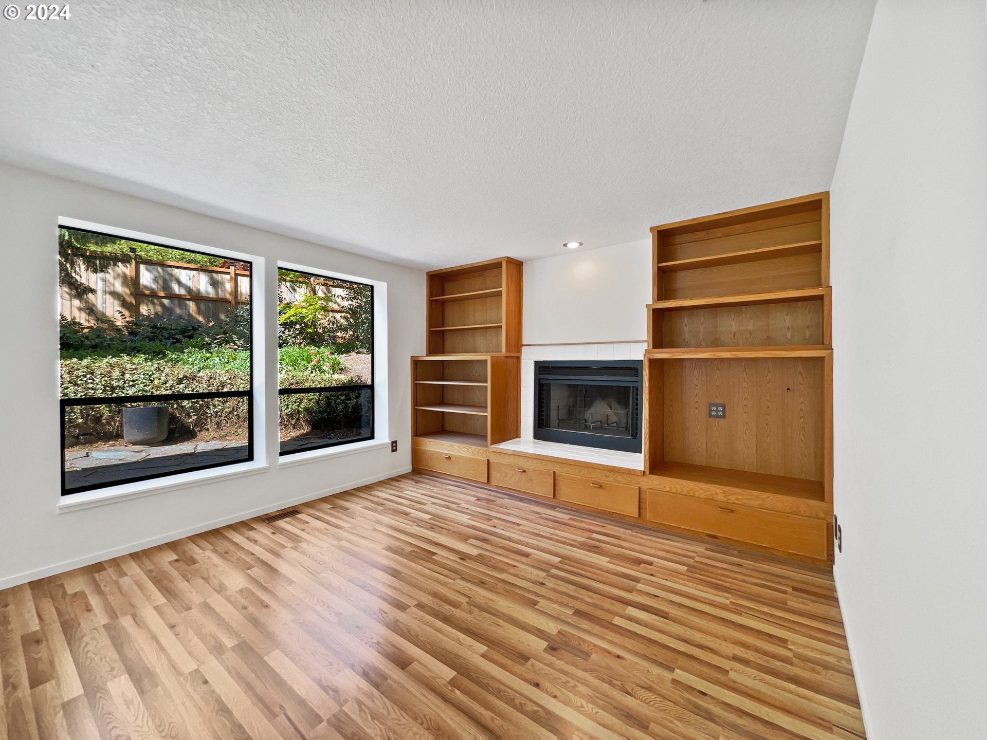 11621 Southwest 43rd Avenue Portland, OR 97219 - Photo 18 of 19 a view of an empty room with a fireplace and a window