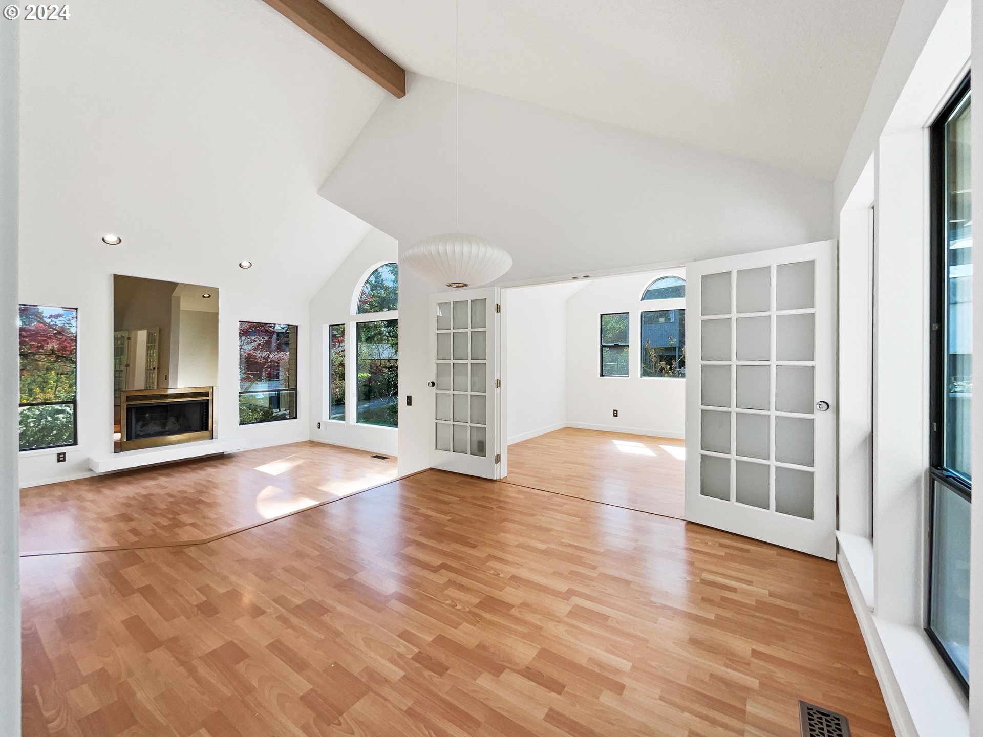 11621 Southwest 43rd Avenue Portland, OR 97219 - Photo 4 of 19 a view of an empty room with wooden floor and a window