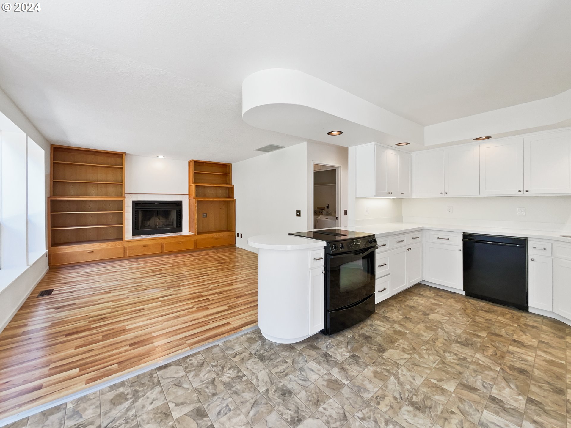 11621 Southwest 43rd Avenue Portland, OR 97219 - Photo 9 of 19 a kitchen with a stove refrigerator and cabinets