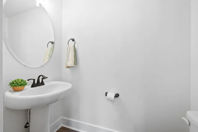 a sign board with a bench in a forest