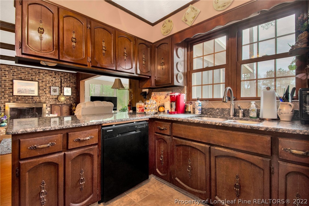 1537 Rice Road Orrum, NC 28369 - Photo 17 of 31 a kitchen with stainless steel appliances granite countertop a sink and cabinets