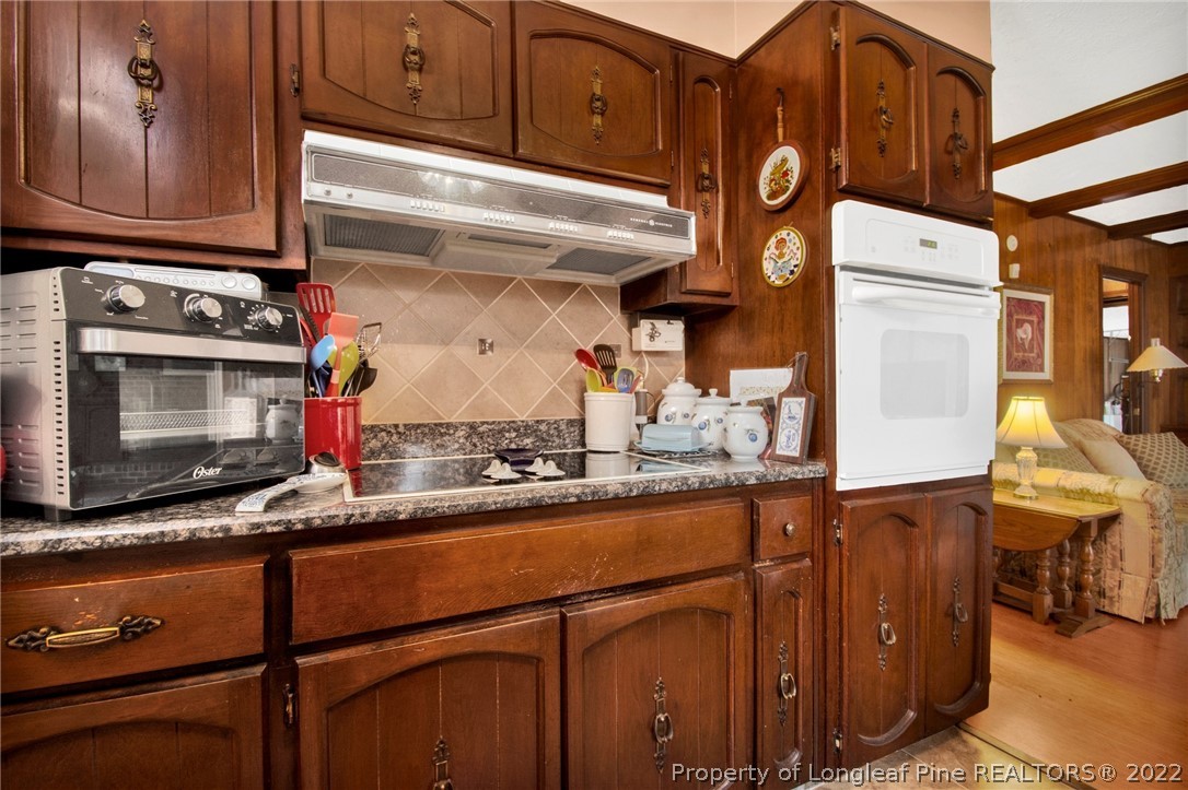 1537 Rice Road Orrum, NC 28369 - Photo 18 of 31 a kitchen with stainless steel appliances granite countertop a sink and cabinets