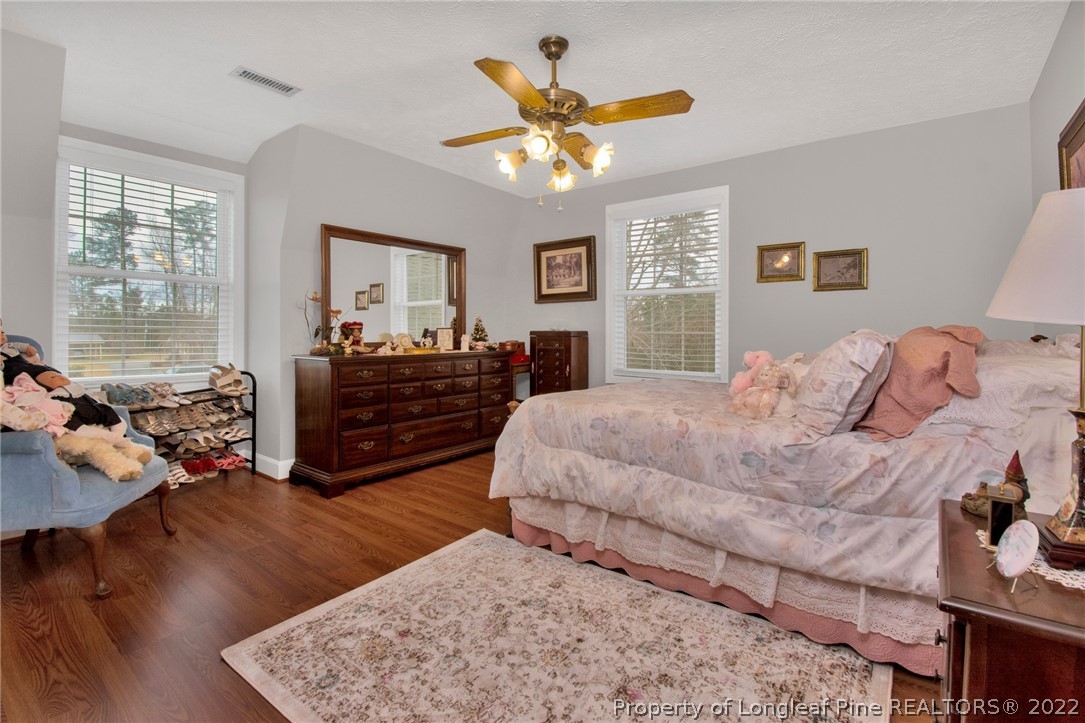 1537 Rice Road Orrum, NC 28369 - Photo 21 of 31 a bedroom with a bed and wooden floor