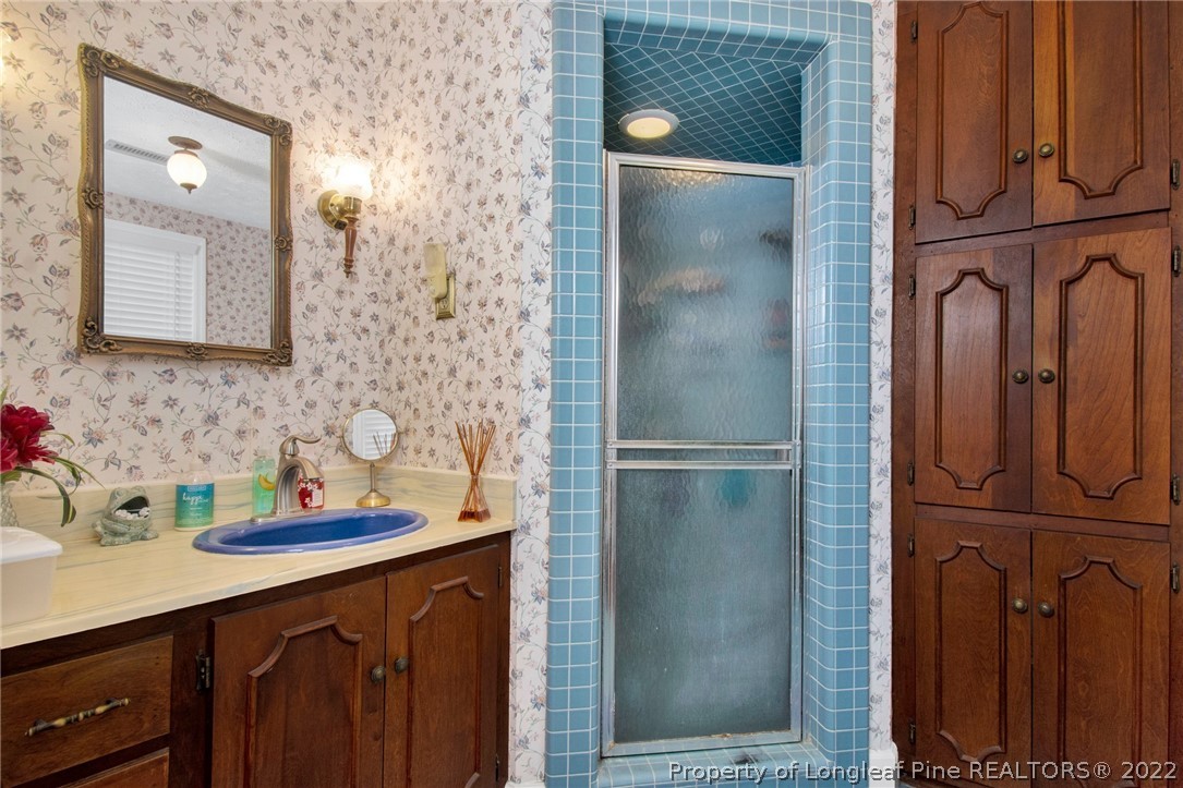 1537 Rice Road Orrum, NC 28369 - Photo 28 of 31 a bathroom with a sink and a mirror