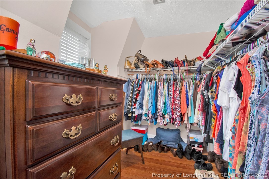 1537 Rice Road Orrum, NC 28369 - Photo 29 of 31 a view of walk in closet with clothes and shoes