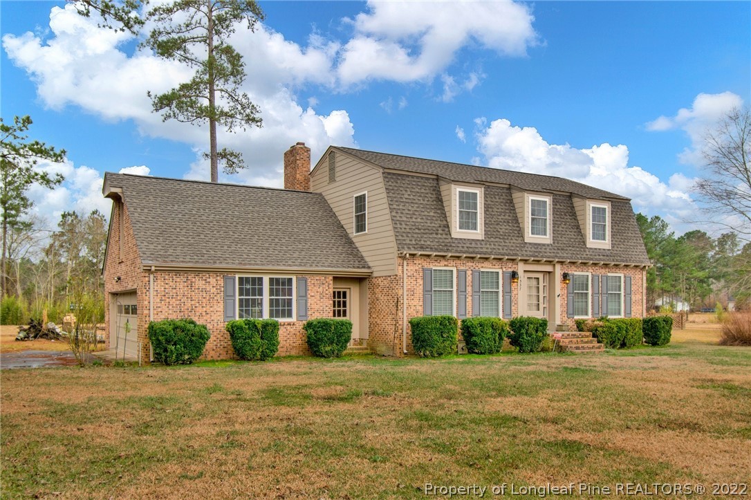 1537 Rice Road Orrum, NC 28369 - Photo 3 of 31 a front view of a house with a garden