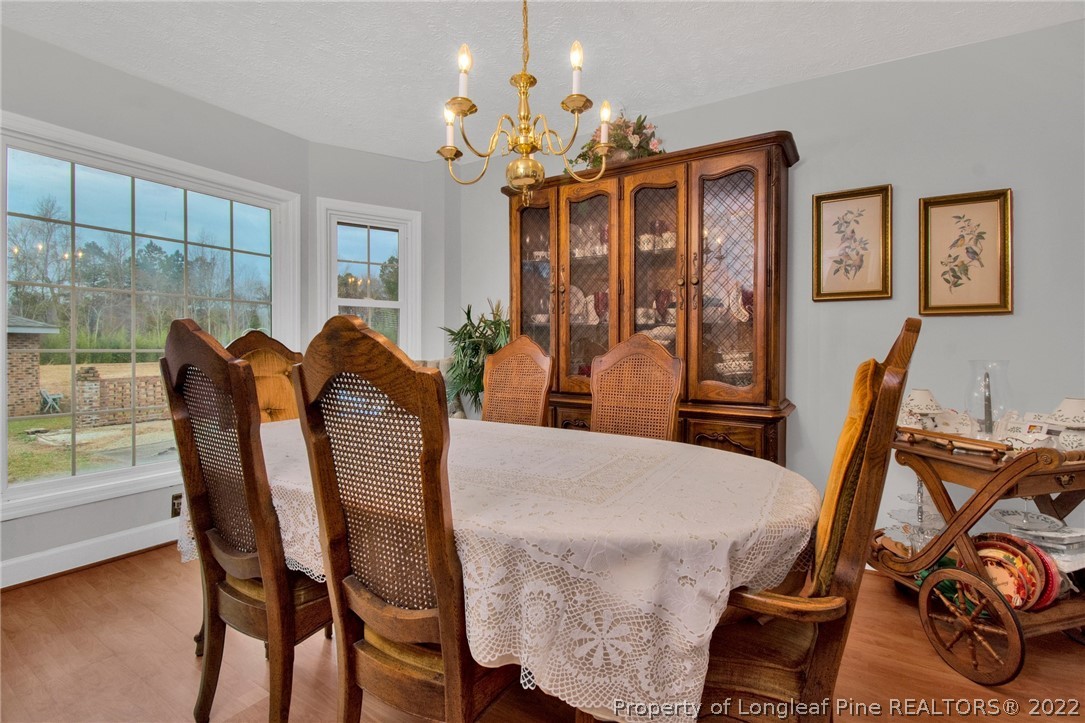 1537 Rice Road Orrum, NC 28369 - Photo 9 of 31 a view of a dining room with furniture and chandelier