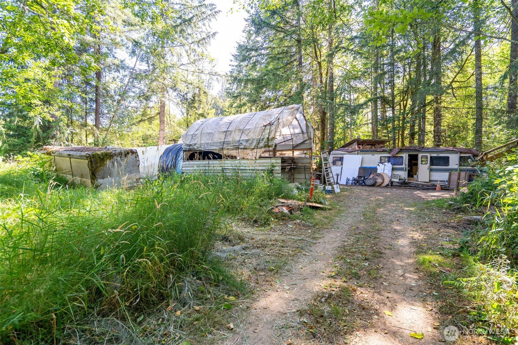 234 Smokey Ridge Road Onalaska, WA 98570 - Photo 13 of 18 a backyard of a house with barbeque oven table and chairs