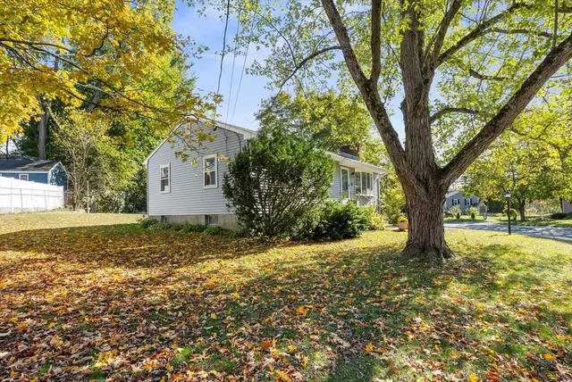 a view of a house with a yard and sitting area