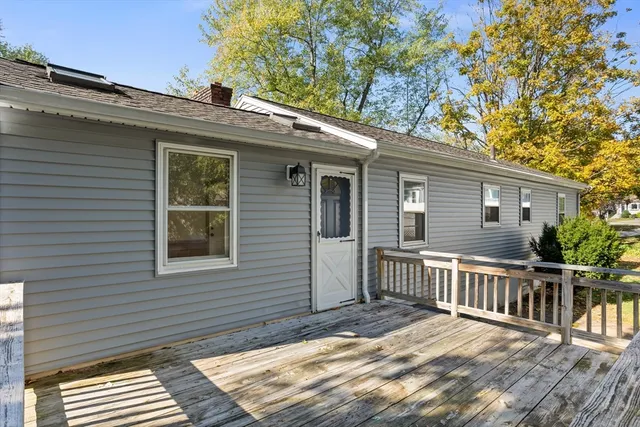 a view of a balcony with wooden floor and fence