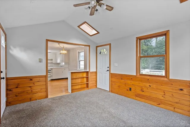 a view of a kitchen with wooden floor and electronic appliances