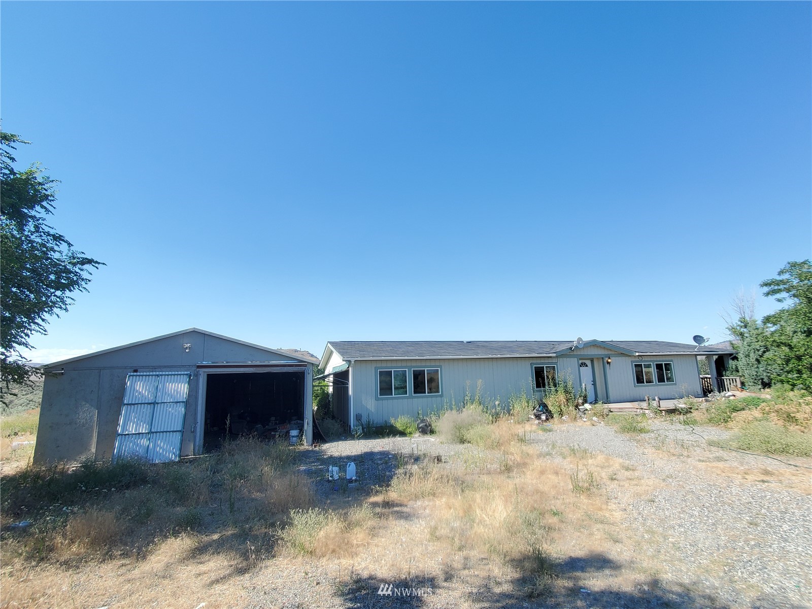 20 Rosewood Lane Riverside, WA 98849 - Photo 1 of 11 a front view of a house with a yard