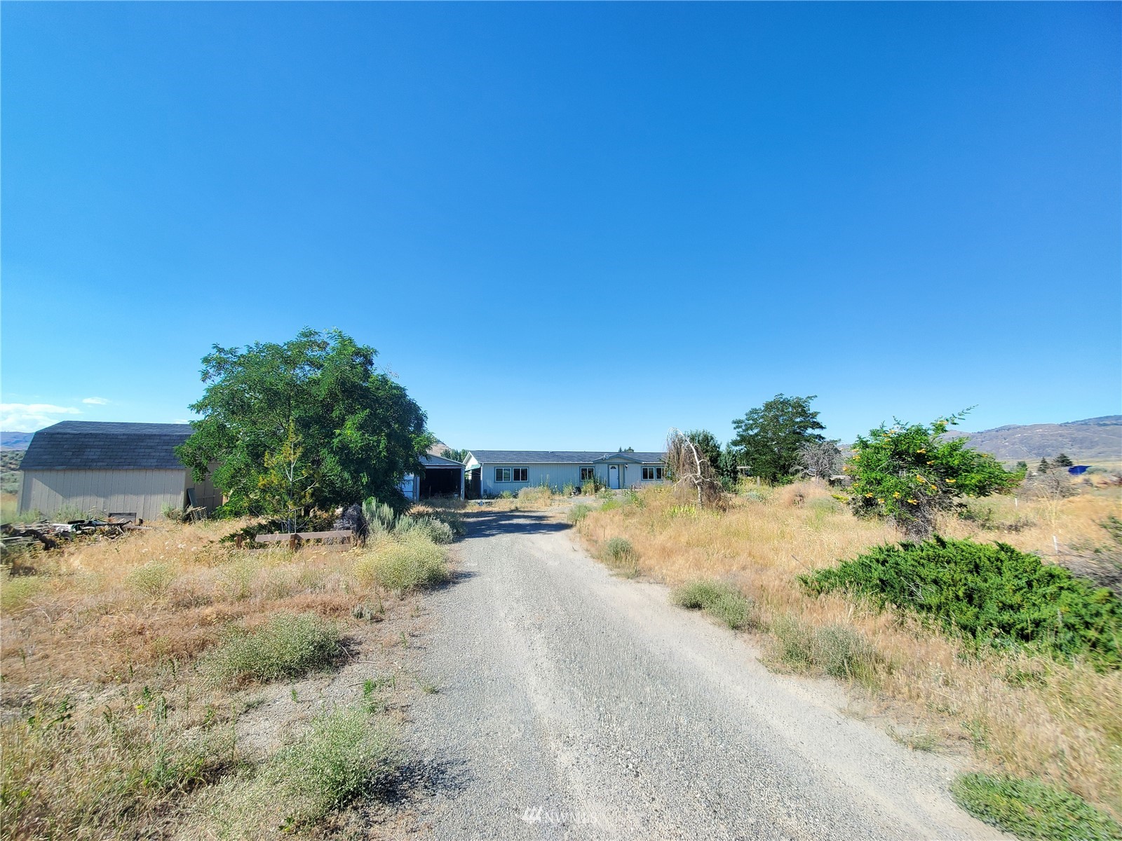 20 Rosewood Lane Riverside, WA 98849 - Photo 5 of 11 a view of a dirt road with a building in the background