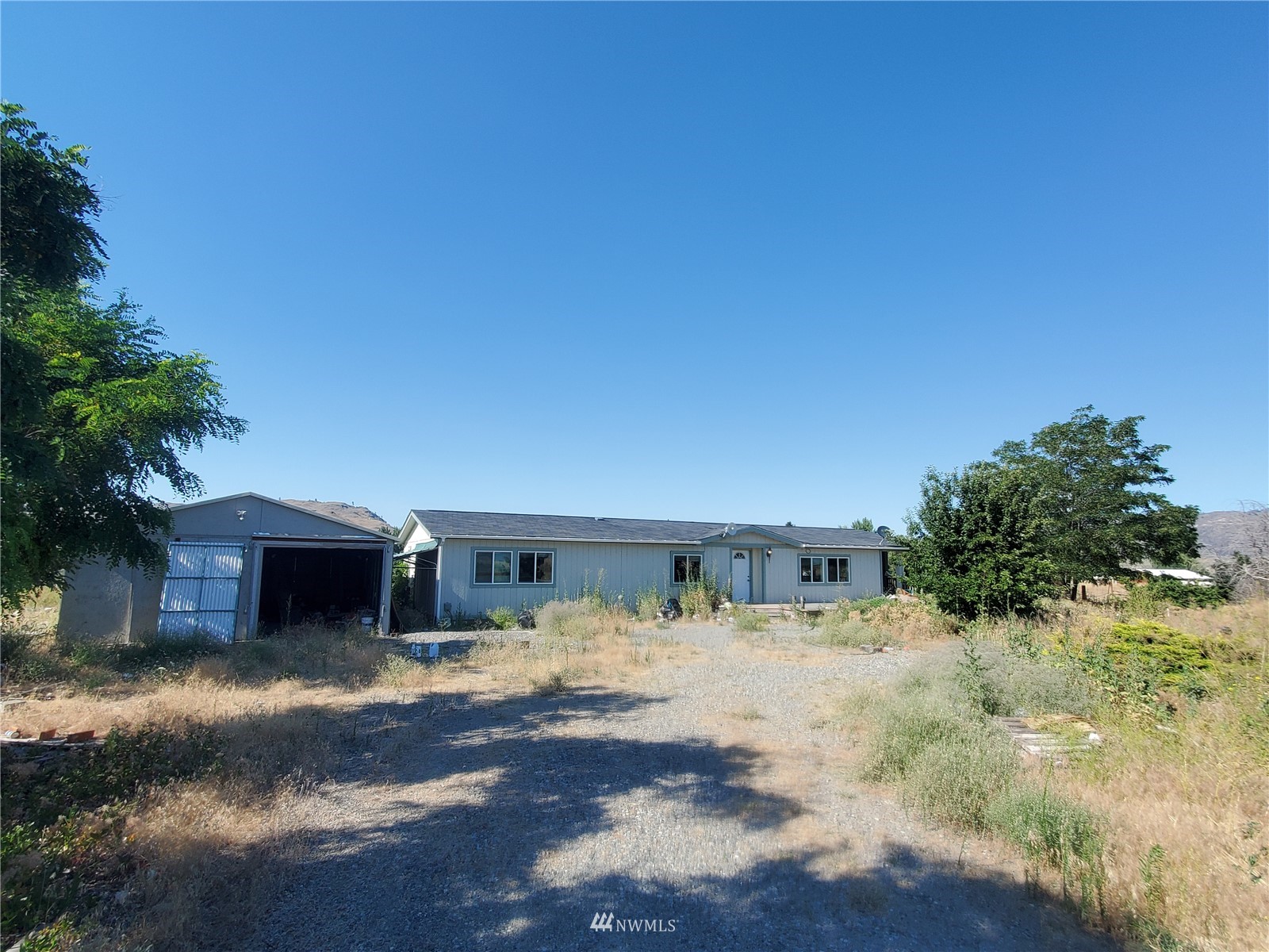 20 Rosewood Lane Riverside, WA 98849 - Photo 6 of 11 a view of a house with a yard