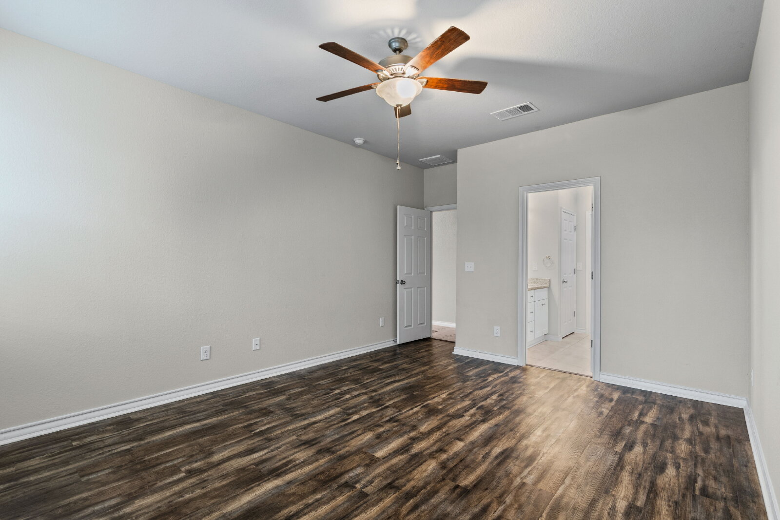 204 Tulum Terrace Leander, TX 78641 - Photo 13 of 22 Unfurnished bedroom with ceiling fan and dark wood-type flooring