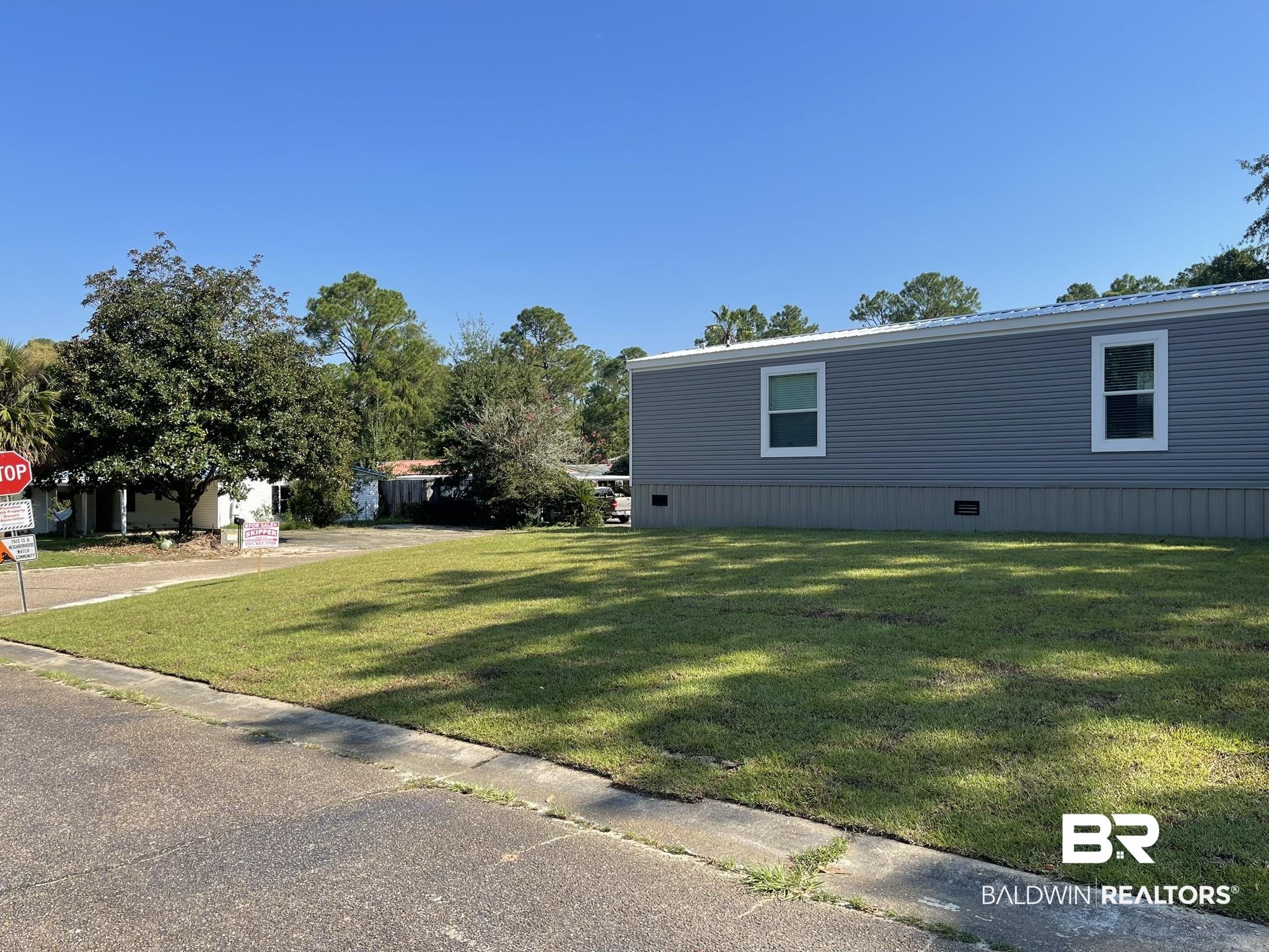 9592 Redfish Drive Elberta, AL 36530 - Photo 2 of 8 View of side of property featuring a yard and a metal roof