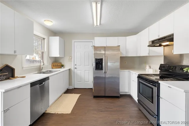 a kitchen with a sink stove and refrigerator