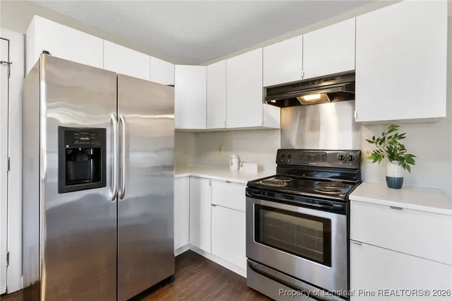 a kitchen with a stove and a refrigerator