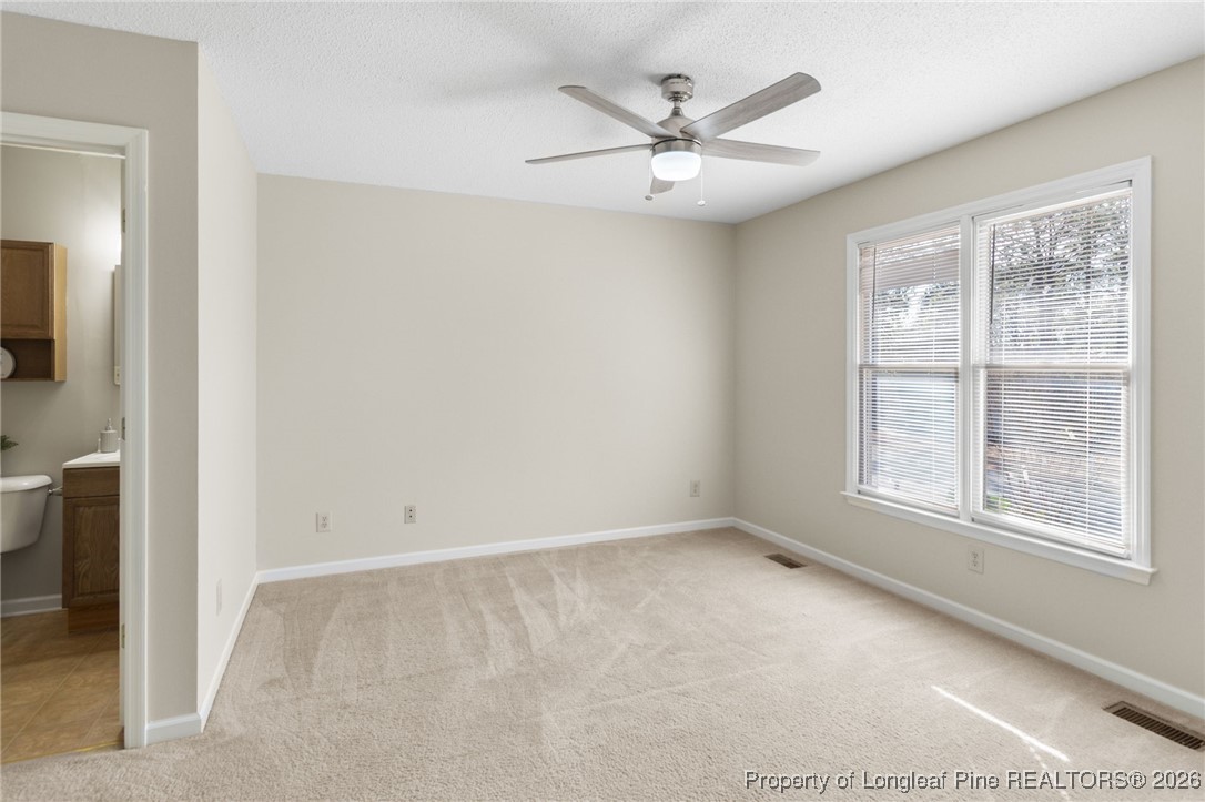 3340 Hunting Bay Drive Spring Lake, NC 28390 - Photo 14 of 28 an empty room with windows and fan