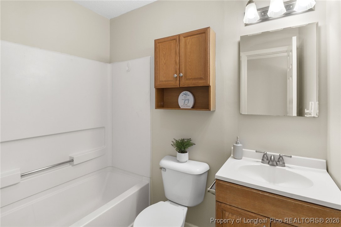 3340 Hunting Bay Drive Spring Lake, NC 28390 - Photo 17 of 28 a bathroom with a sink and a mirror