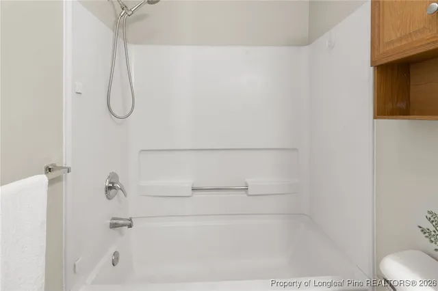 a bathroom with a bath tub with a shower