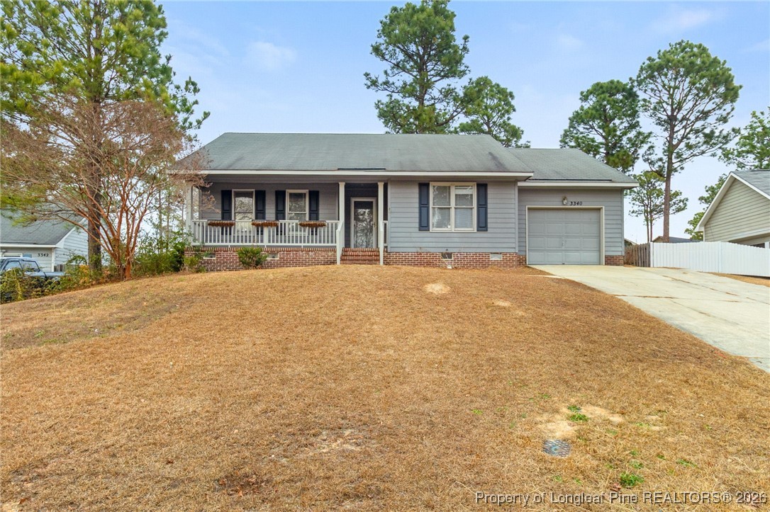 3340 Hunting Bay Drive Spring Lake, NC 28390 - Photo 2 of 28 a front view of house with yard and trees around
