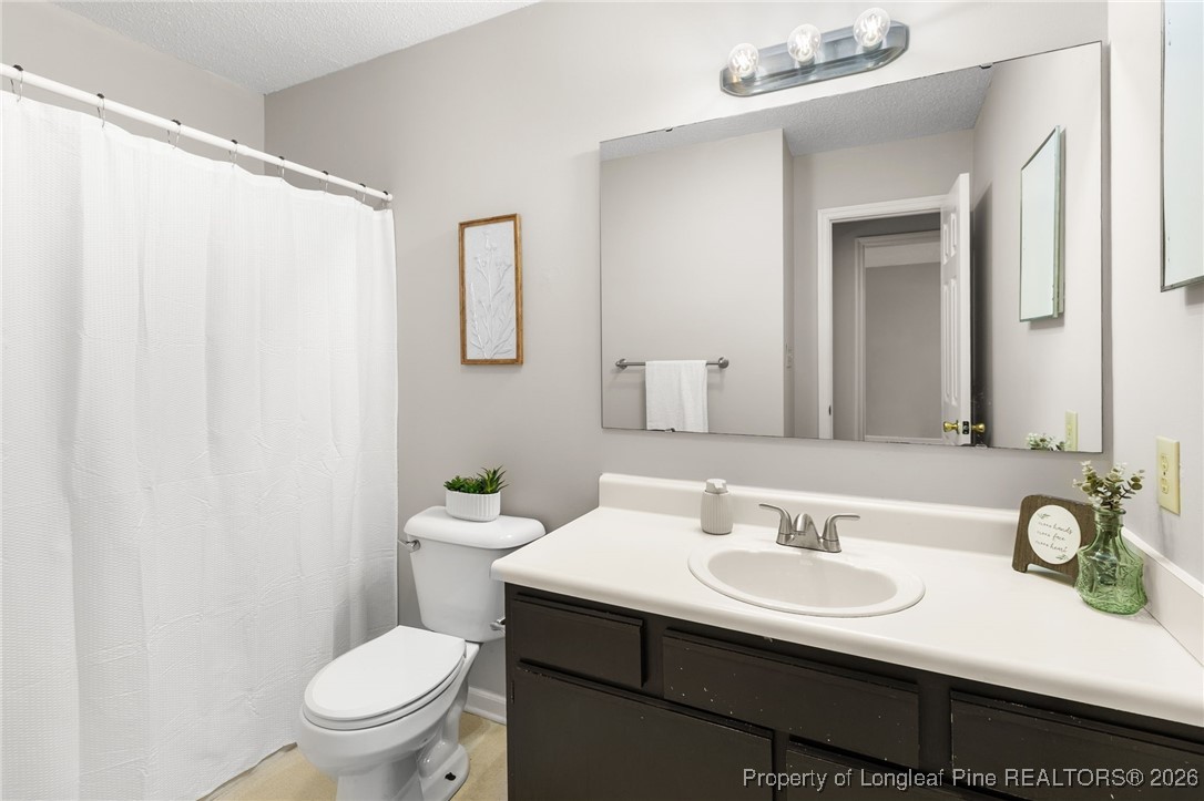 3340 Hunting Bay Drive Spring Lake, NC 28390 - Photo 21 of 28 a bathroom with a sink and a mirror