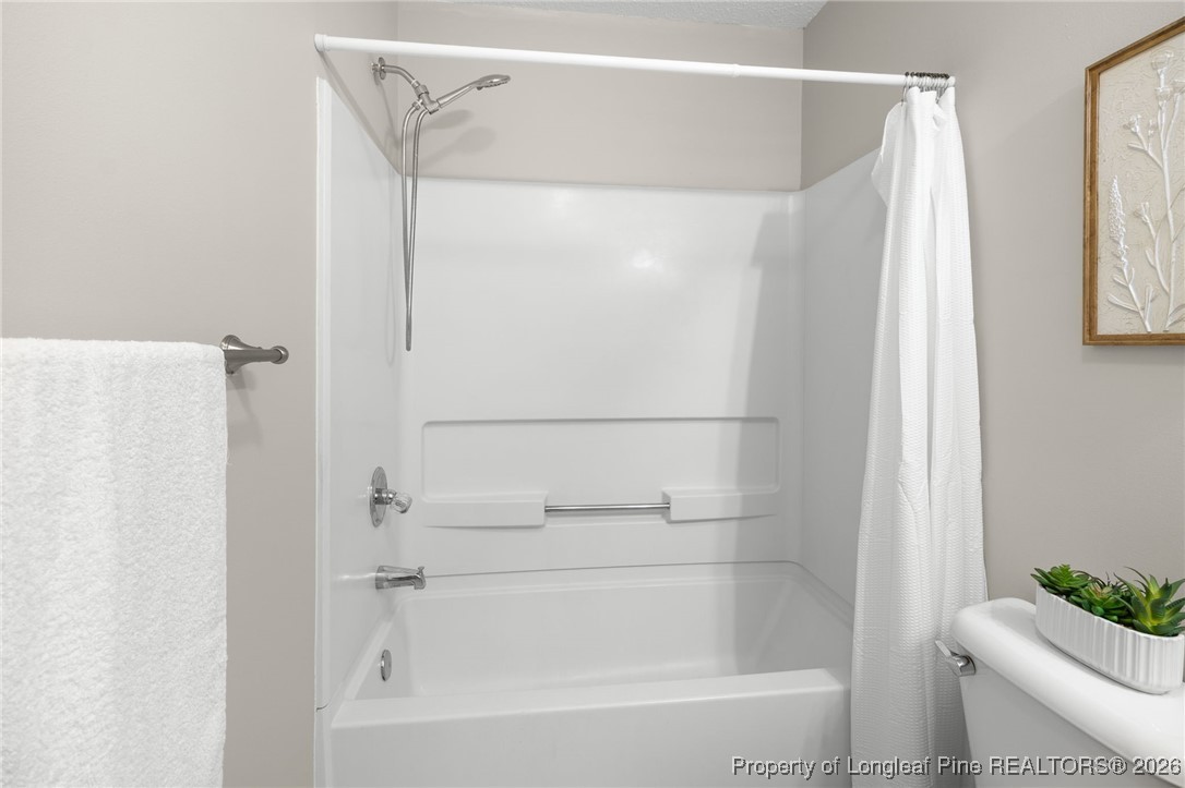 3340 Hunting Bay Drive Spring Lake, NC 28390 - Photo 22 of 28 a bathroom with a shower and a bath tub