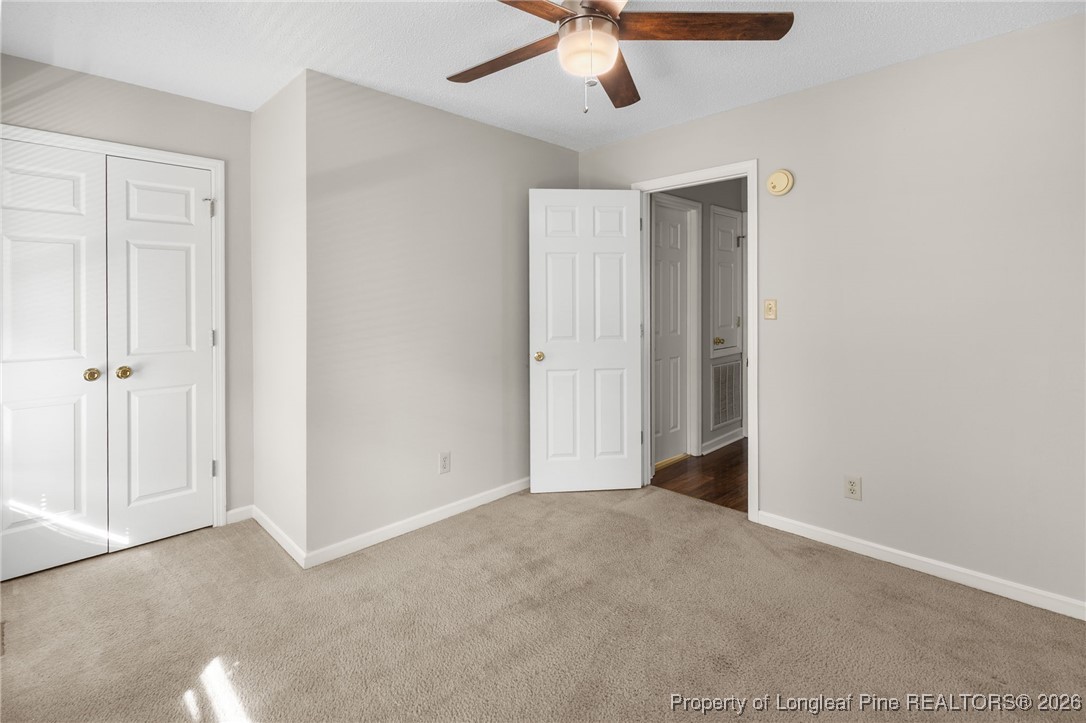 3340 Hunting Bay Drive Spring Lake, NC 28390 - Photo 24 of 28 an empty room with a ceiling fan and carpet