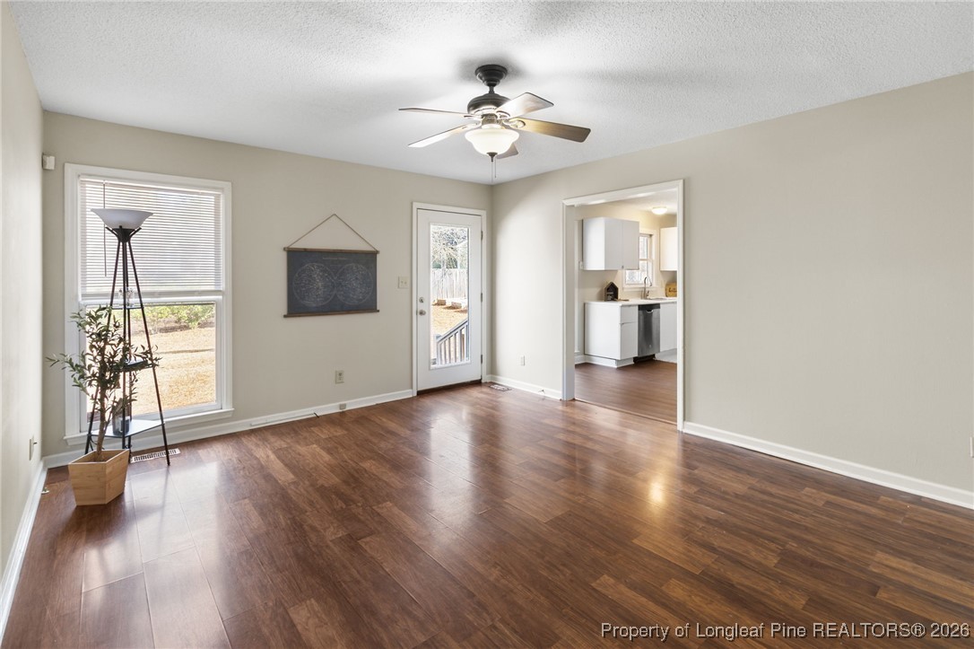 3340 Hunting Bay Drive Spring Lake, NC 28390 - Photo 7 of 28 a view of an empty room with wooden floor and a window