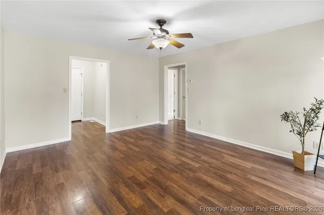 a view of an empty room with wooden floor