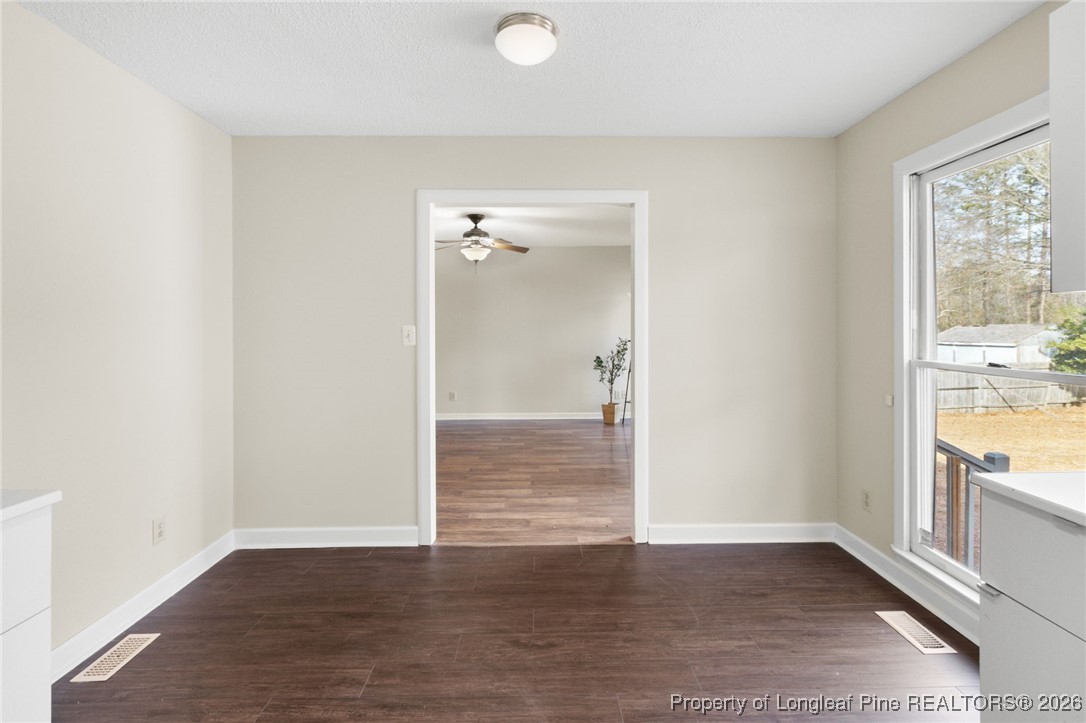 3340 Hunting Bay Drive Spring Lake, NC 28390 - Photo 10 of 28 a view of an empty room with wooden floor and a window