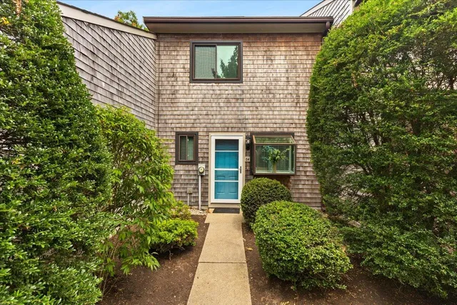 a view of a house with potted plants