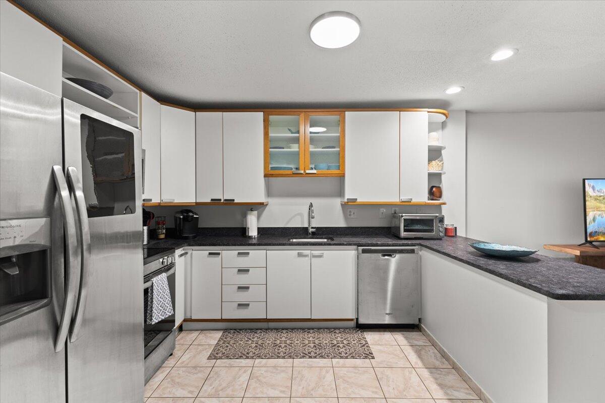84 Round House Road Bourne, MA 02532 - Photo 12 of 35 a kitchen with granite countertop a sink stainless steel appliances and cabinets