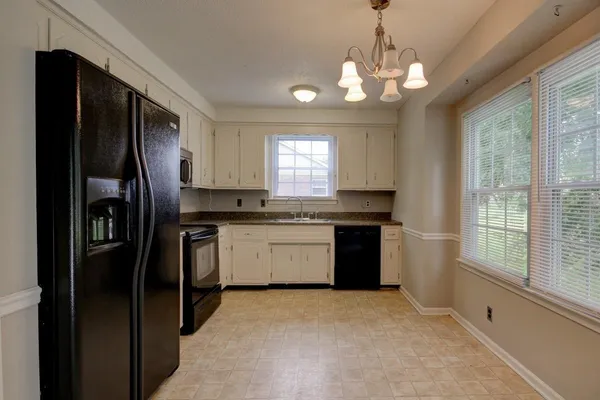 a kitchen with a refrigerator and a sink