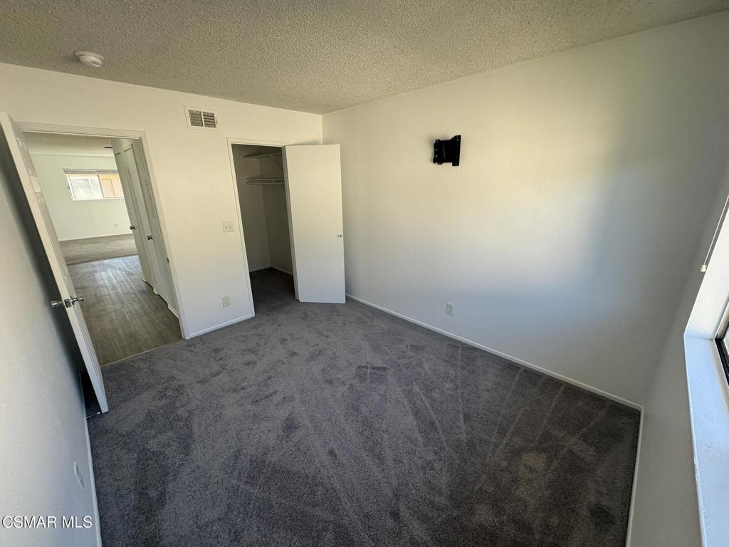 2030 Avenida Placida, Unit 4 Simi Valley, CA 93063 - Photo 9 of 18 a view of a hallway with wooden floor and a bathroom
